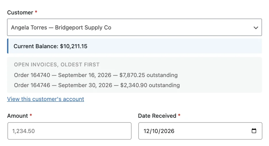 Record Payment form with a customer selected, showing their current balance and their two open invoices listed oldest first, above the amount and date received fields